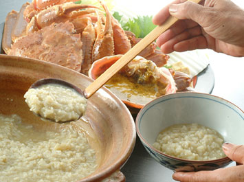 飯物（蟹味噌入り雑炊）[b]カニと野菜の旨味が凝縮したお出汁に、蟹味噌(添加物一切無し)を加えて、雑炊用に味を整え直した、見た目はシンプルな雑炊。風味を活かすために卵をはじめ、ねぎ等の薬味も一切入れません。